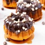 A few mini cakes on the table glazed with chocolate.