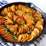 A skillet with sweet potato slices.