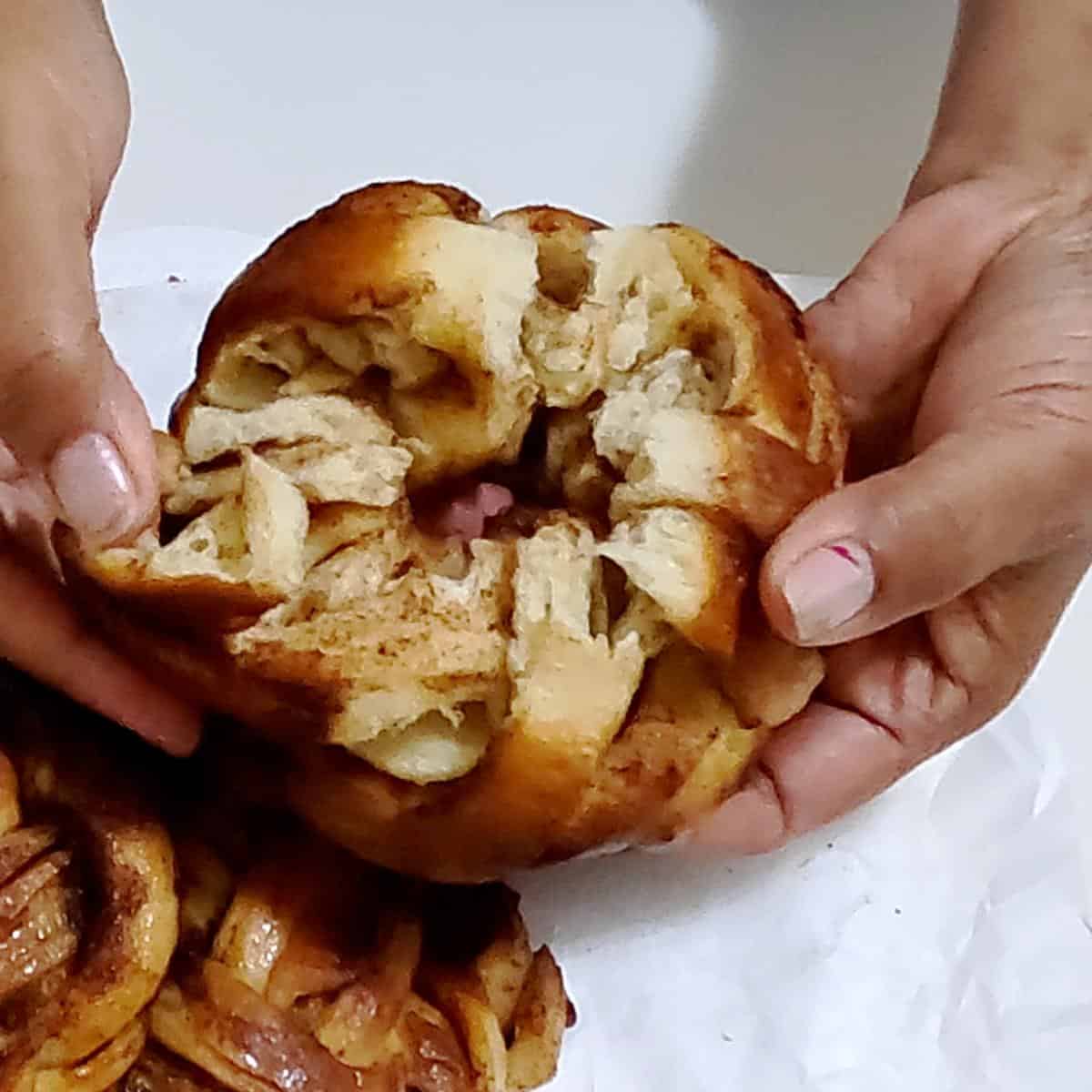 Breading a cinnamon bun.