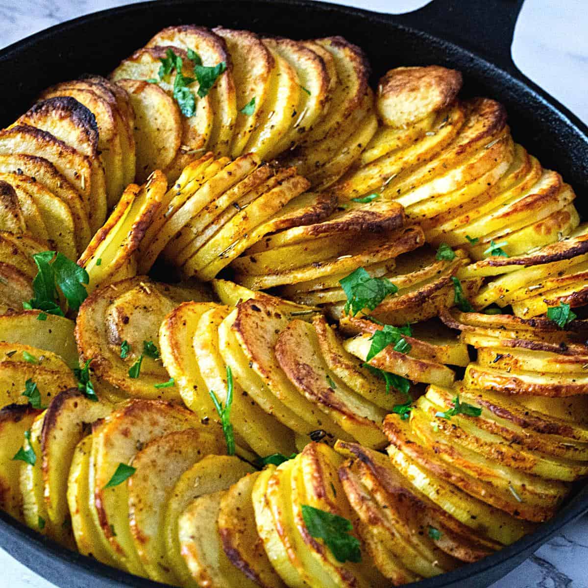A cast iron skillet with potatoes baking.