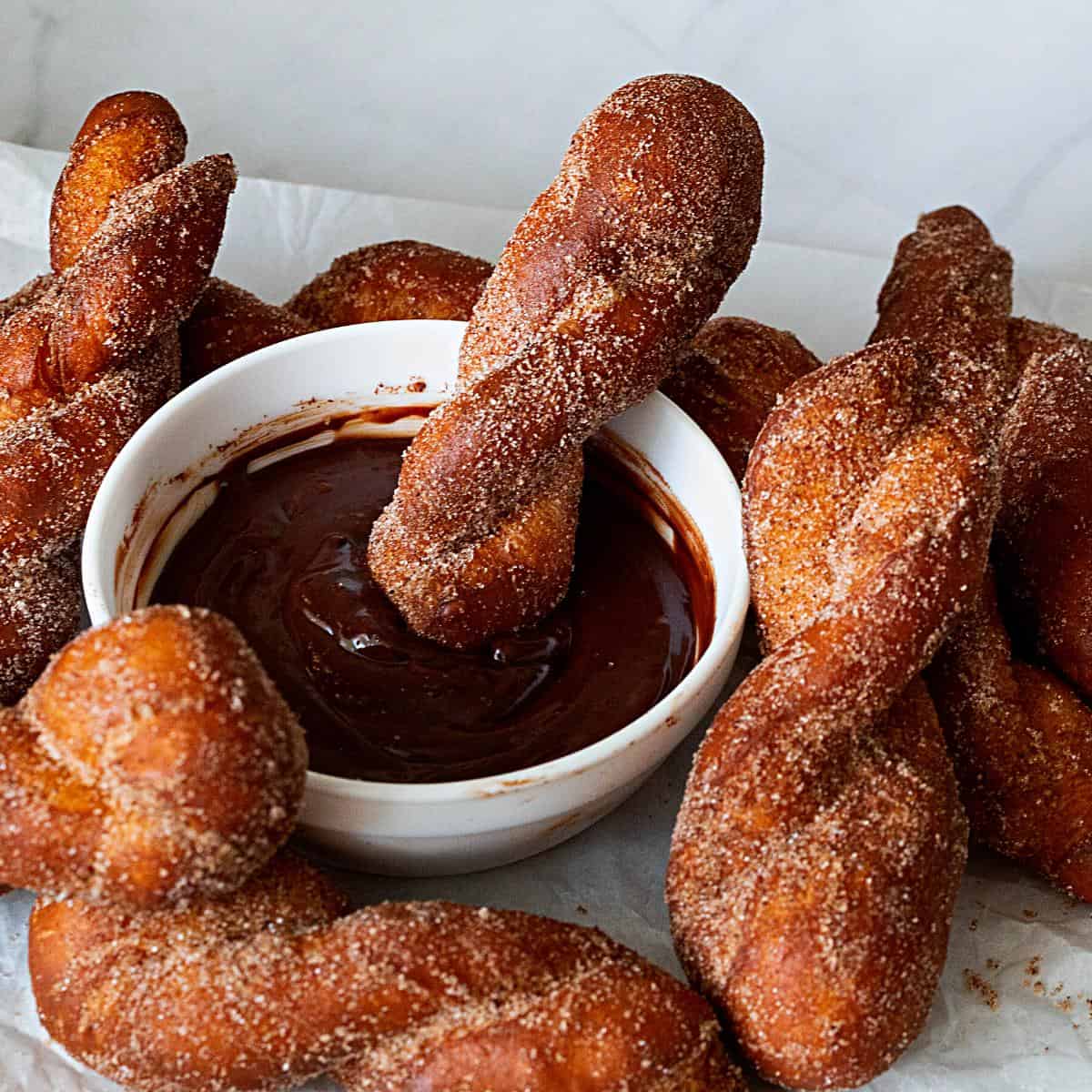 Chocolate sauce and twisted fried donuts.