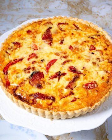 A baked quiche with artichokes.