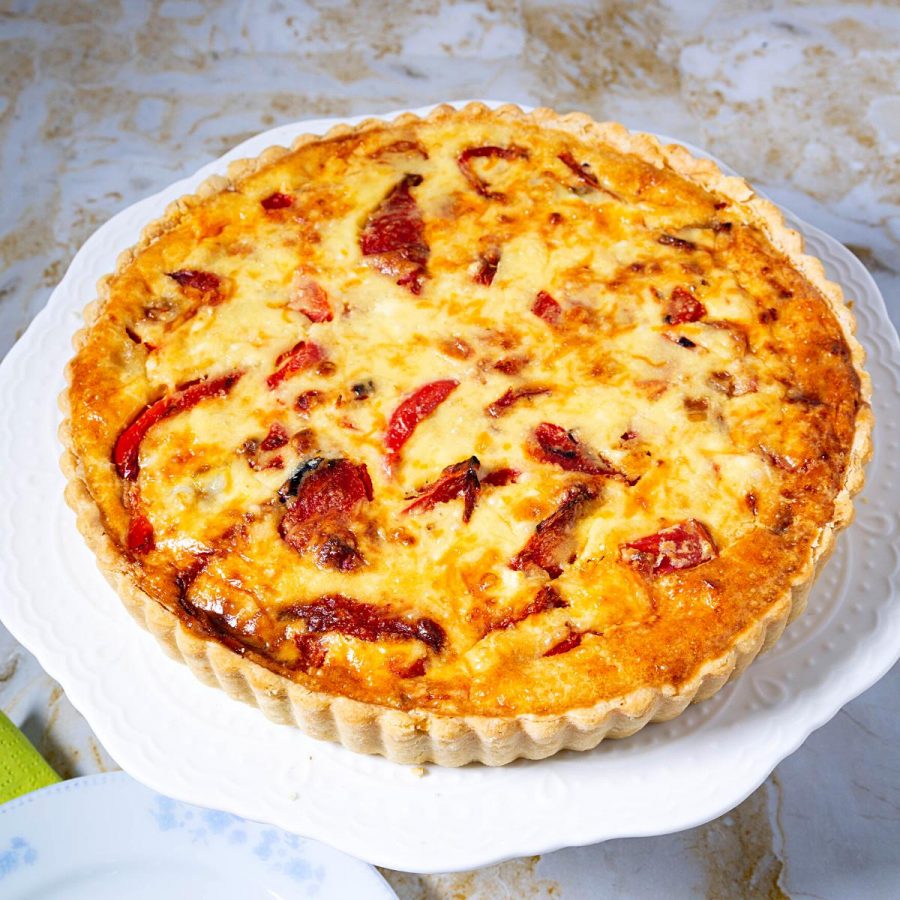 A baked quiche with artichokes.