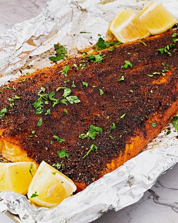 A large salmon fillet on the baking tray.