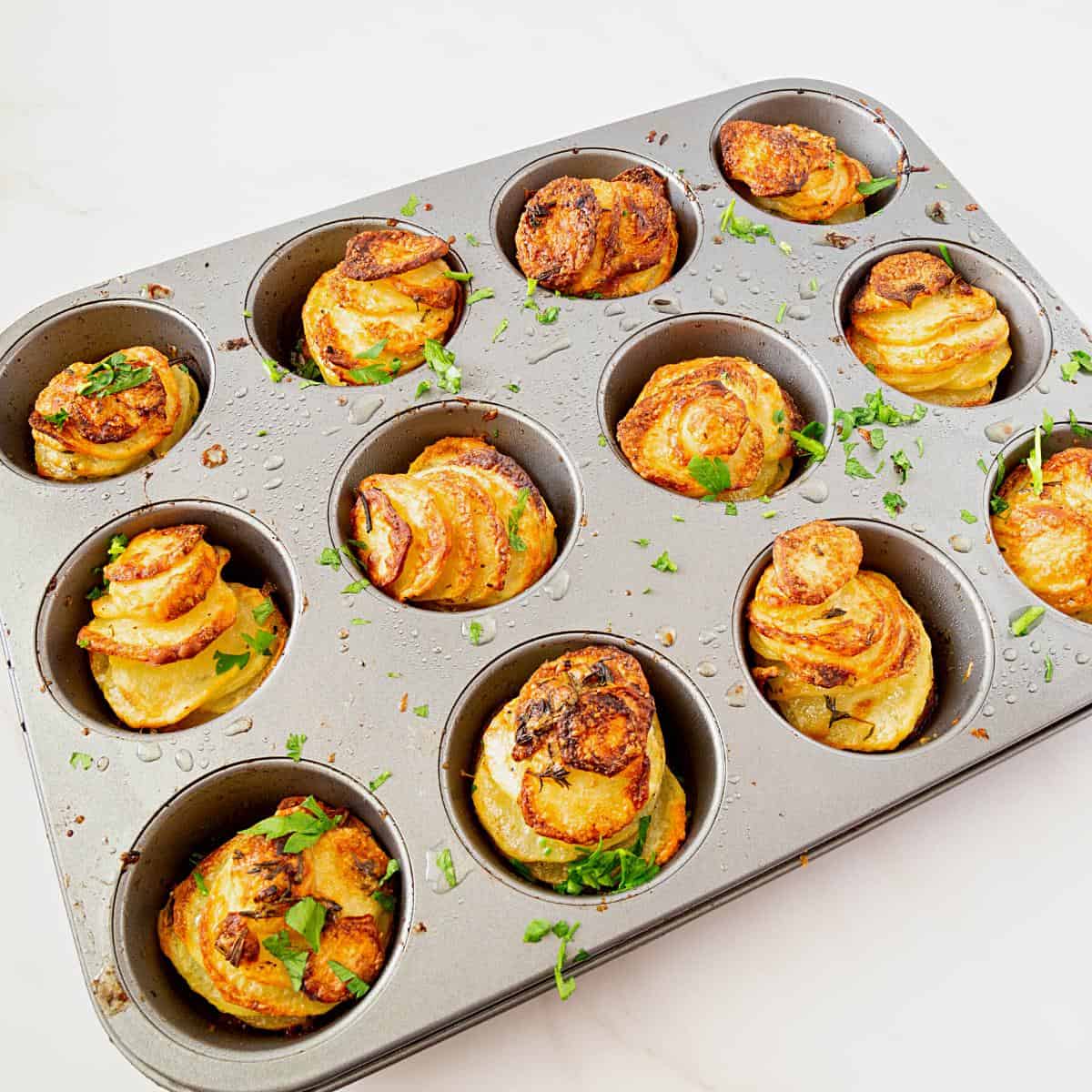 A muffin tin with sliced potatoes.