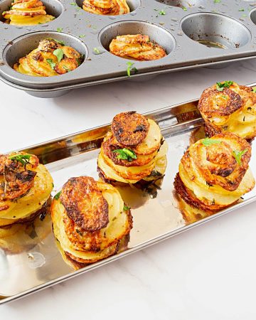 Potato stacks in a muffin tray.