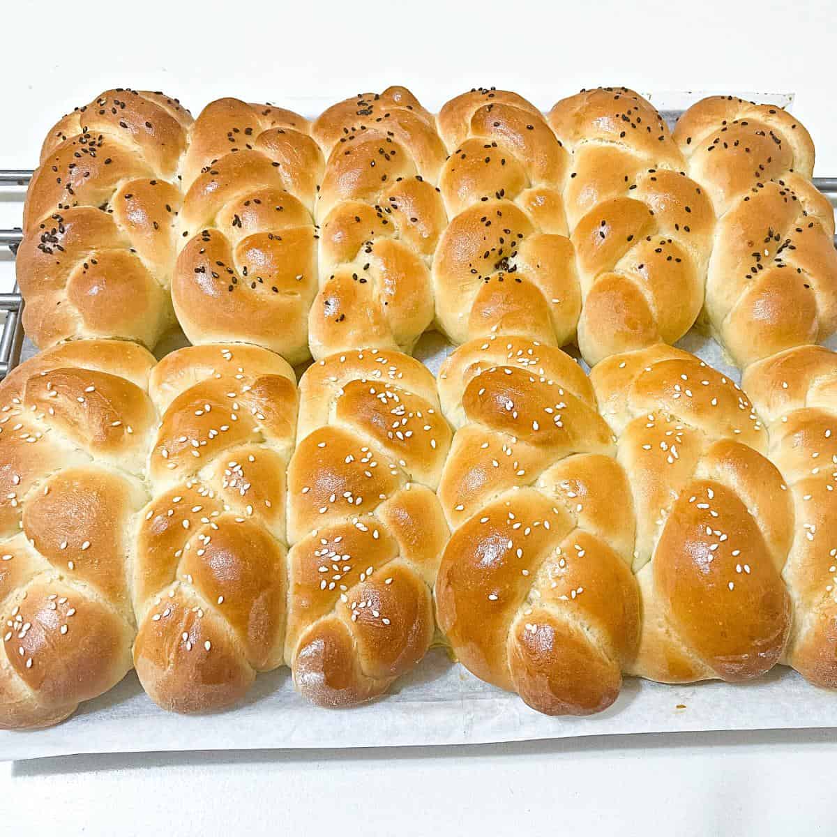 12 challah braided rolls on the table.