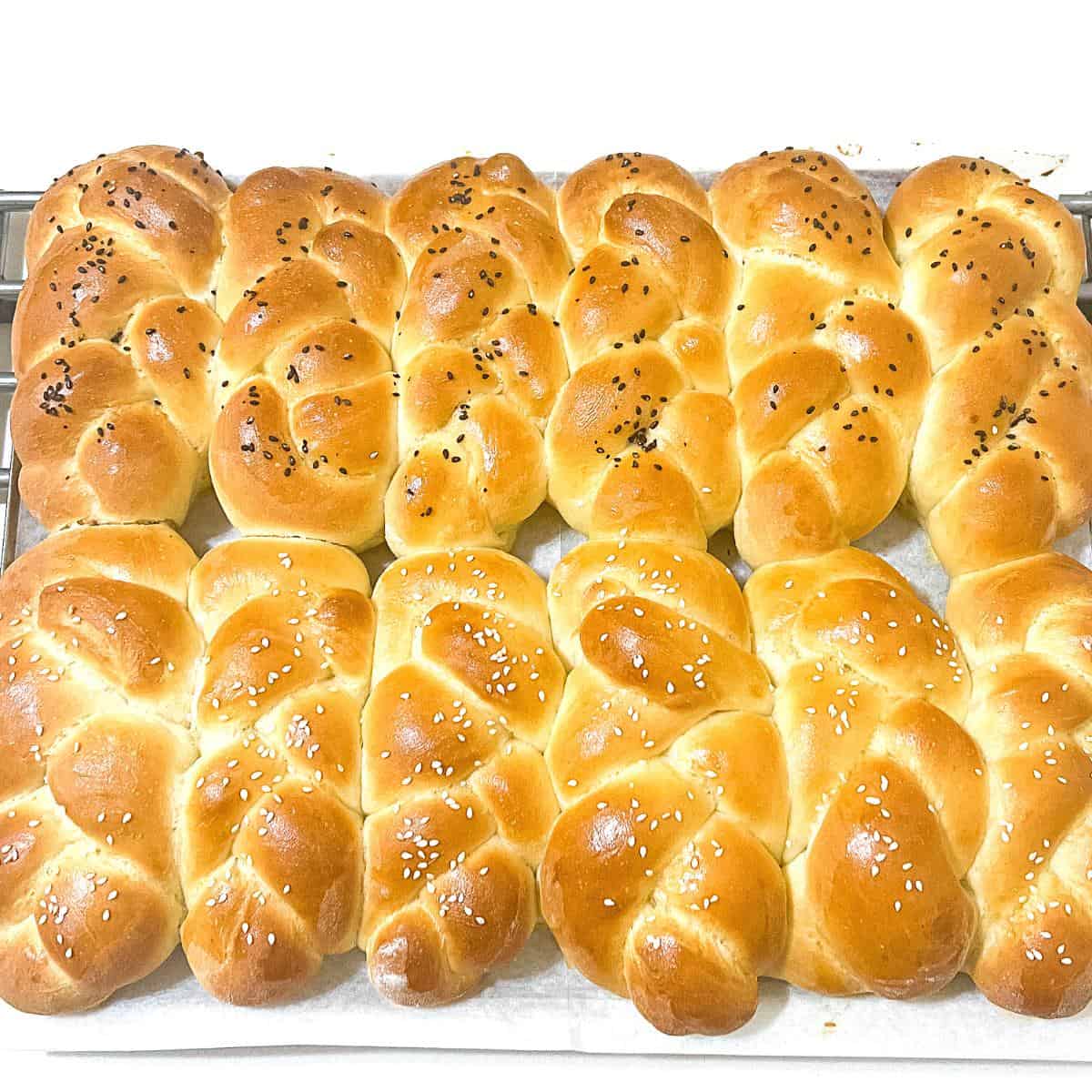 A slab of braided dinner rolls on the table.