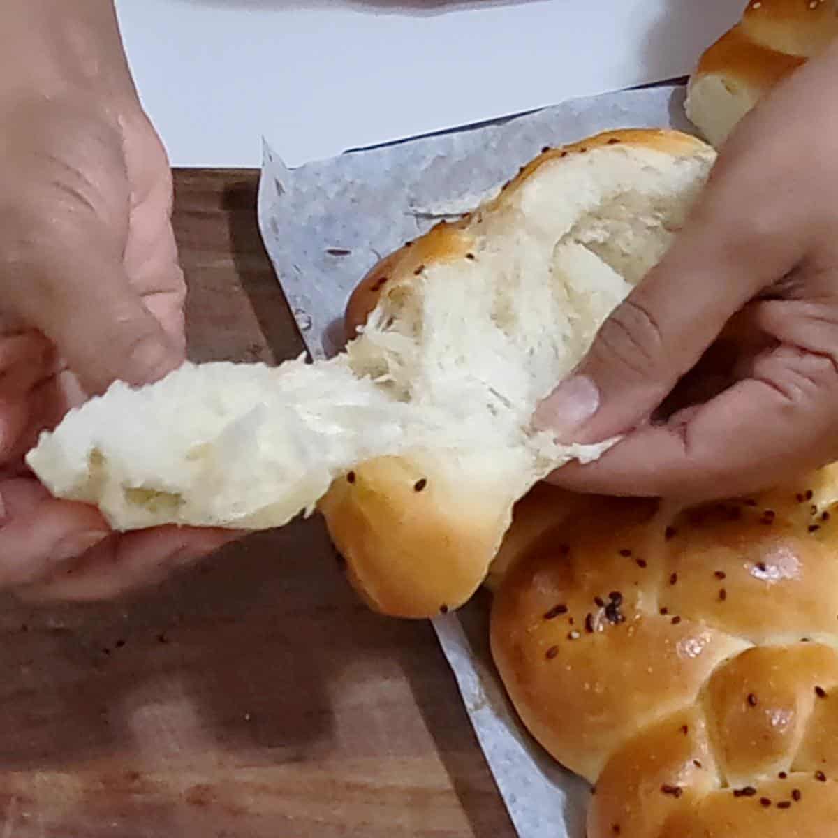 Showing the inside of the soft and fluffy challah.