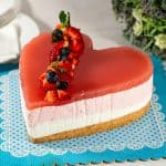 A heart shaped cake on the cake board.