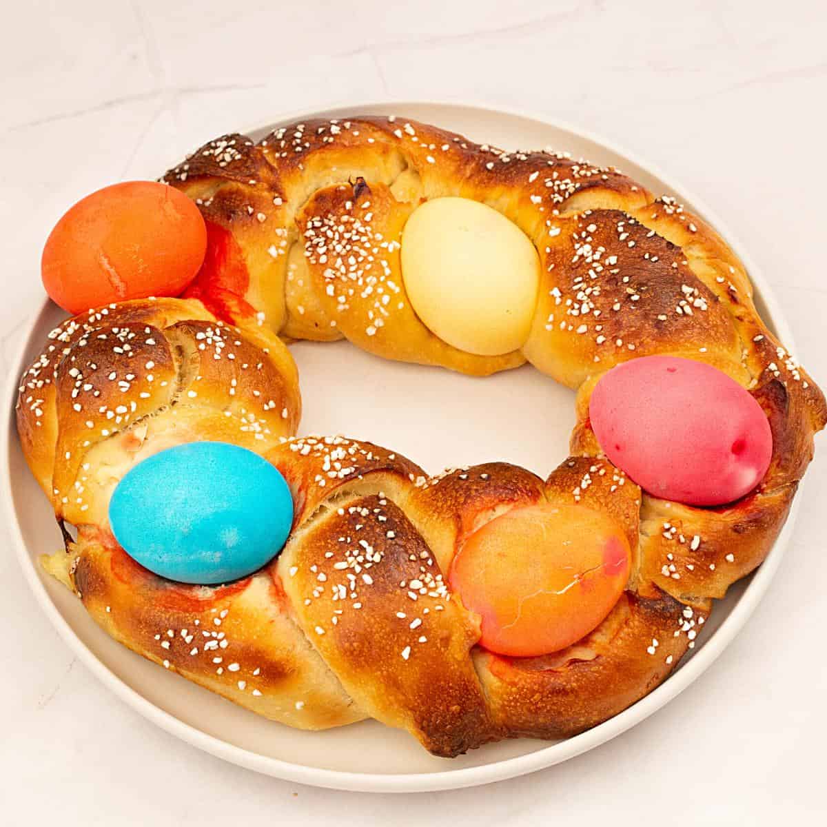 A baked braided bread with easter eggs.