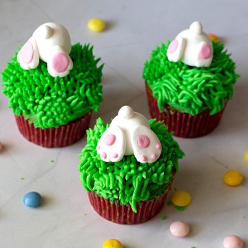 Cupcakes with grass frosting and bunny butts.