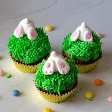 Grass frosted cupcakes with bunny butts.