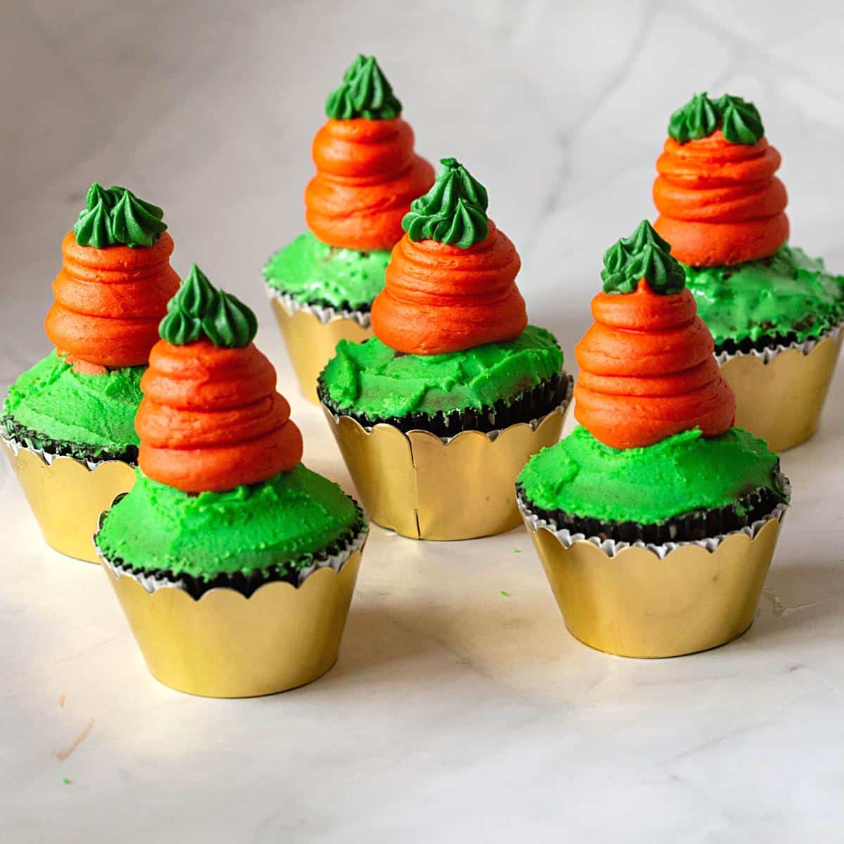 Cupcakes for Easter frosted with orange carrots.