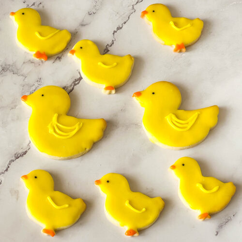 Chick shaped cookies on the table.