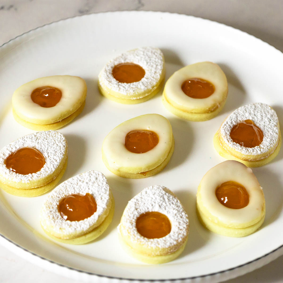 A platter with egg shaped Easter Sugar Cookies.