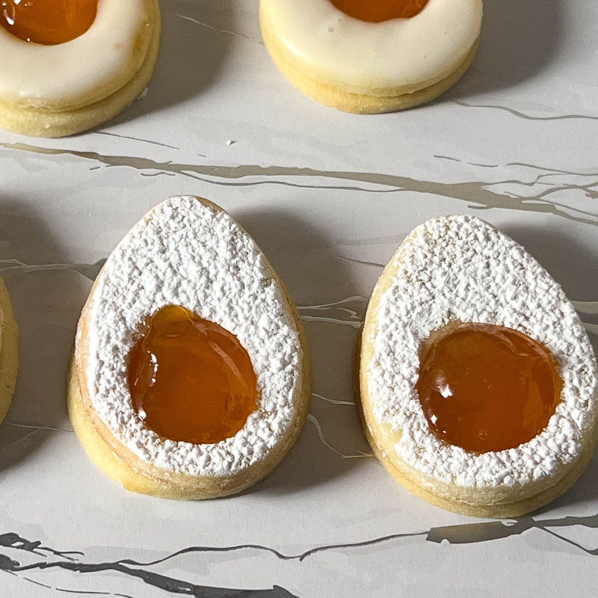 Egg shaped sandwich cookies with apricot jam.