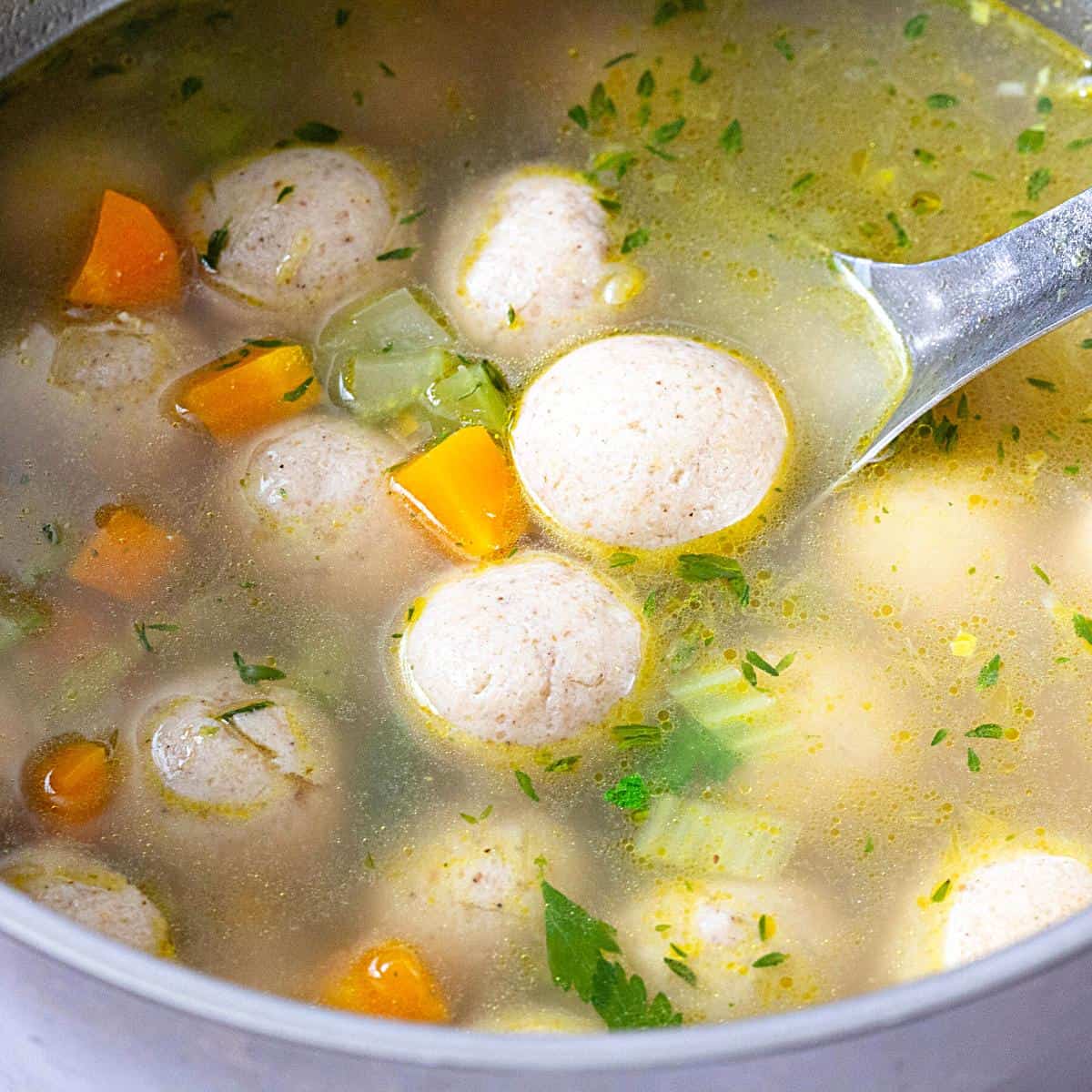 Matzo balls and chicken soup in a pot.