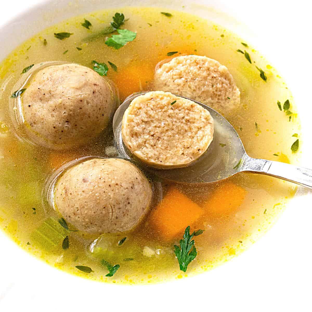 A bowl with matzo ball soup.