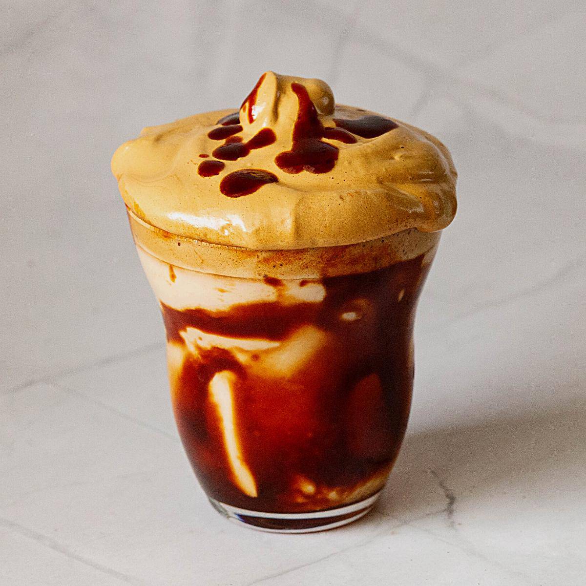 A glass with caramel coffee.