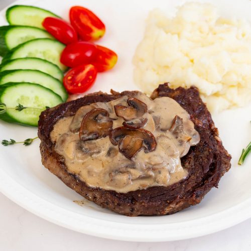 Steak sauce served on a steak with mashed potatoes.