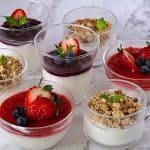 Cheesecake in jars topped with pie filling.