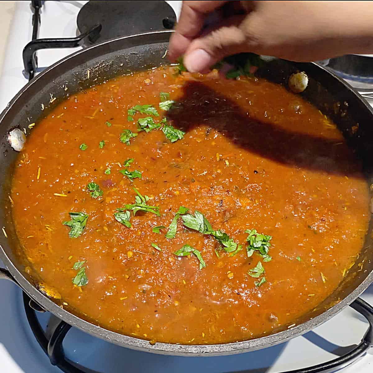 A skillet with tomato sauce.