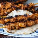 Chicken skewers on a pita.