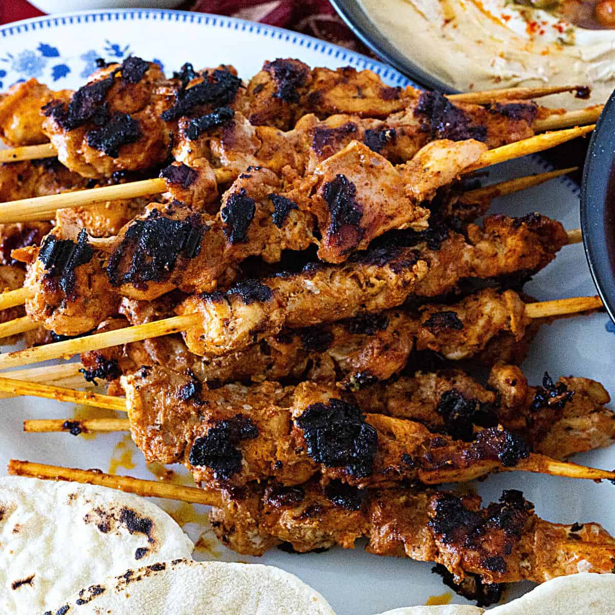Chicken shish skewers on a platter.