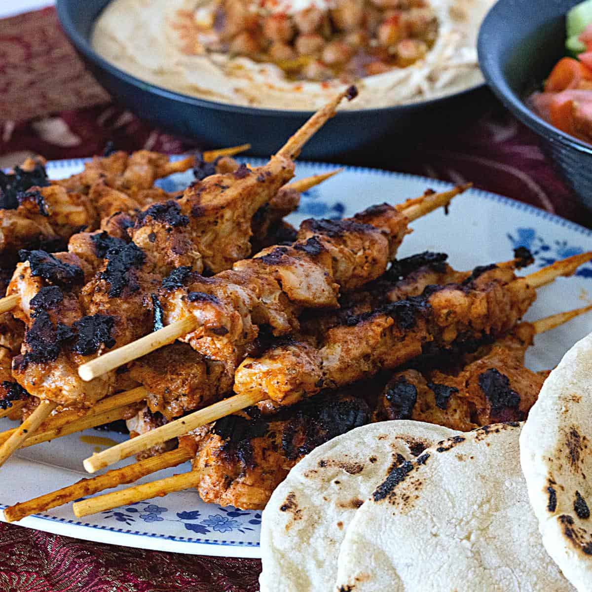 Skewers with hummus and salad.