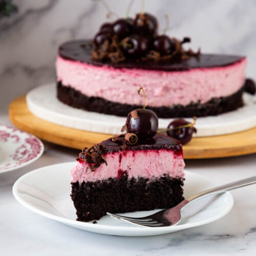 A sliced cherry mousse cake with chocolate.