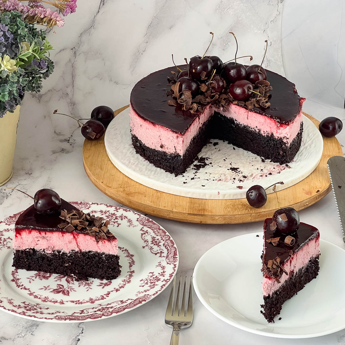 A sliced cherry chocolate mousse cake.