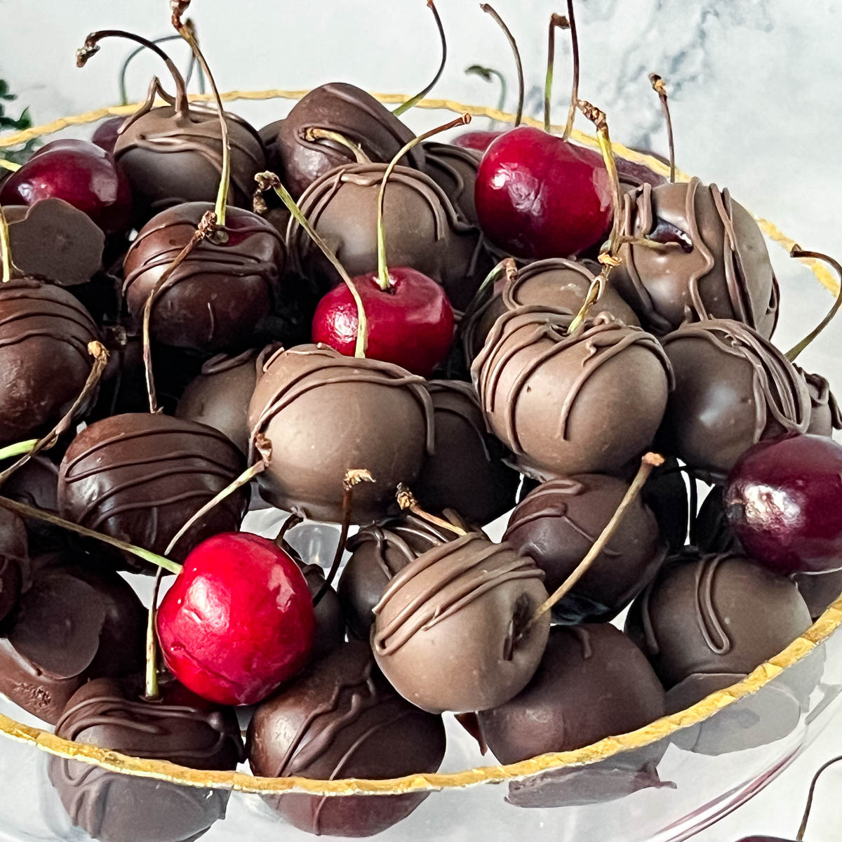 A platter with chocolate cherries.