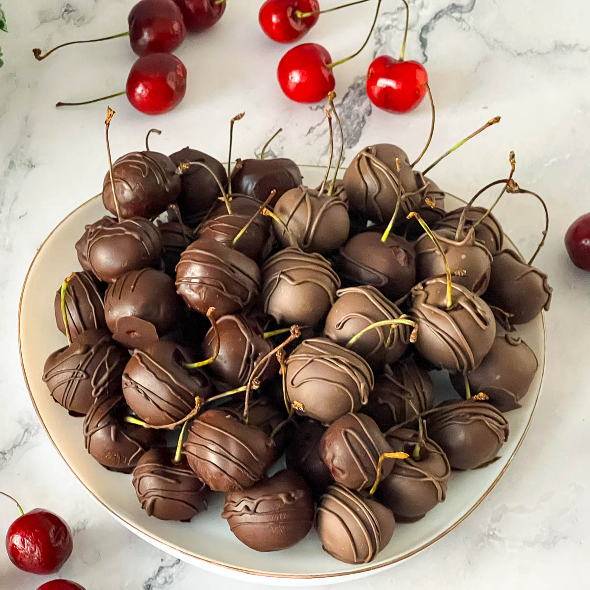A plate with fresh cherries on a platter.
