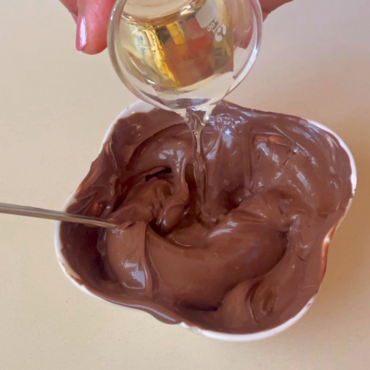 Adding coconut oil to milk chocolate for dipping.