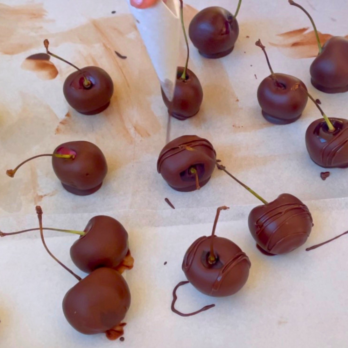 Drying chocolate covered cherries on a tray.