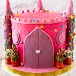 A castle cake with towers and turrets.