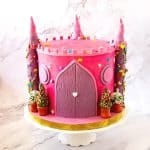 A castle cake with towers and turrets.
