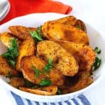 A bowl with spicy roasted potatoes.