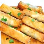 Wooden board with phyllo rolls.