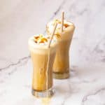 Two glasses with caramel latter.