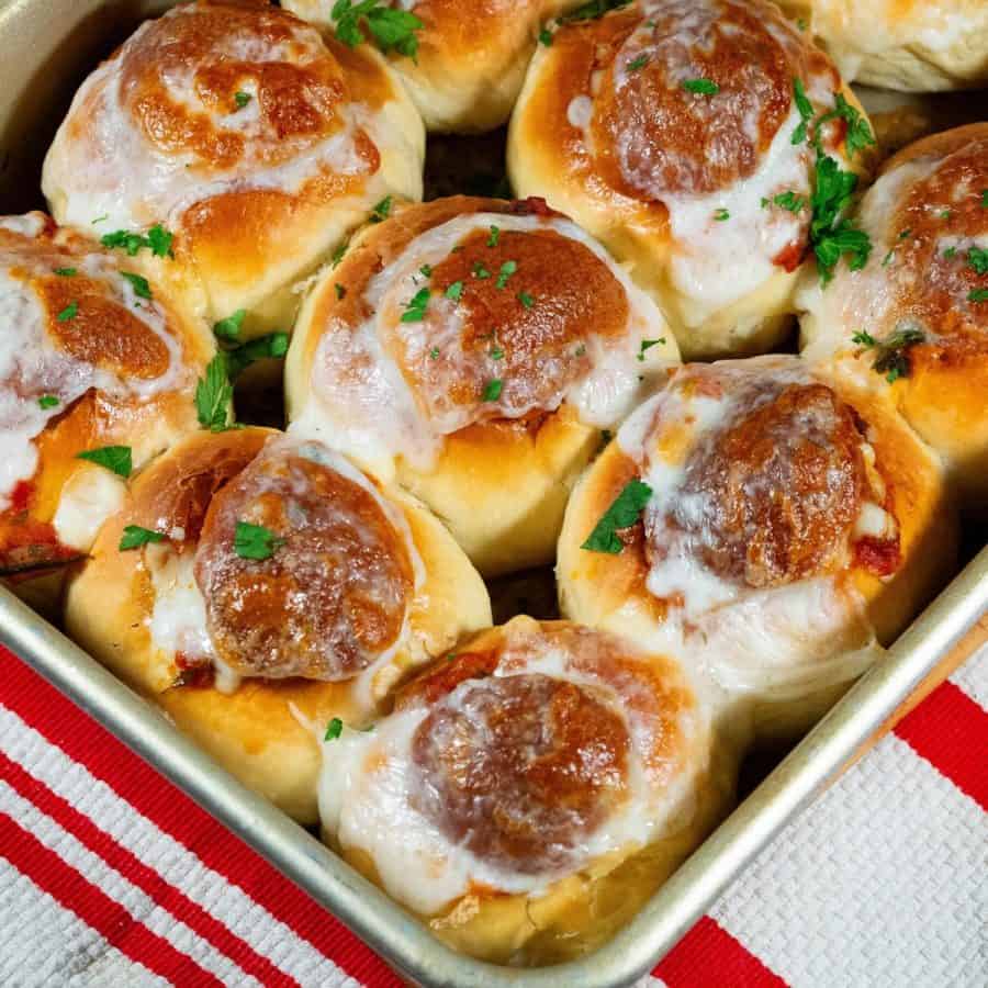 A sheet pan with meatball sliders.