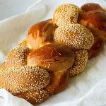 A baked challah with sesame seeds.