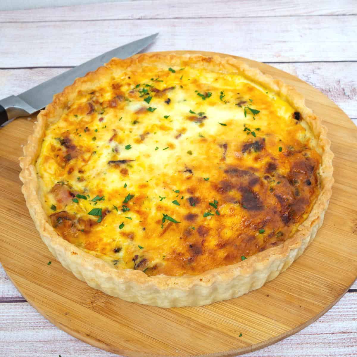 A whole baked quiche on the table.