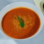 A bowl with tomato soup.