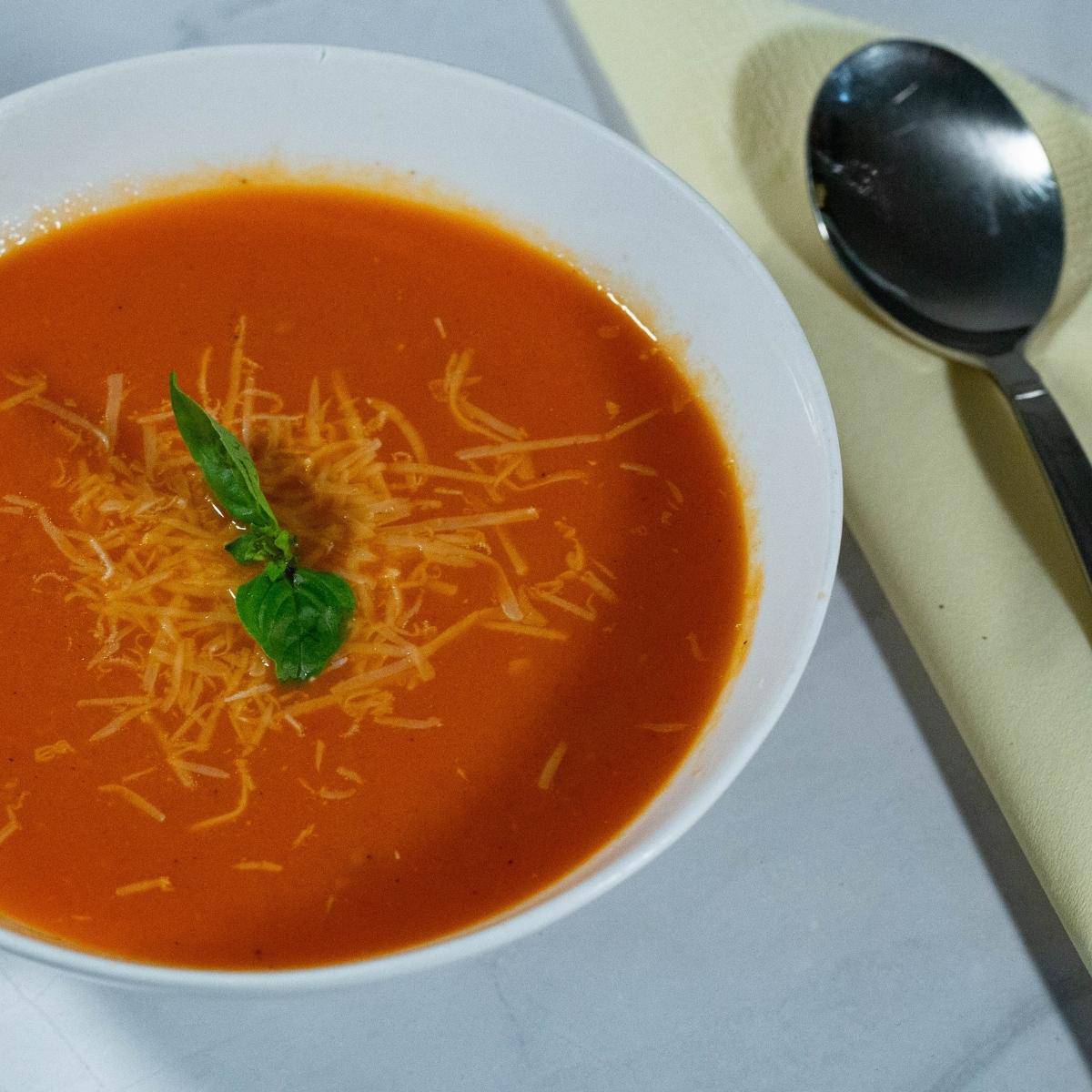 A bowl with soup made with tomatoes.