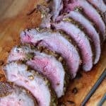 Wooden board with slices of beef tenderloin.