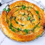 A pie pan with spinach feta phyllo pastry.
