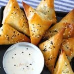 A black plate with phyllo triangles.