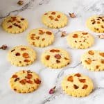 Shortbread with rose petals on the table.